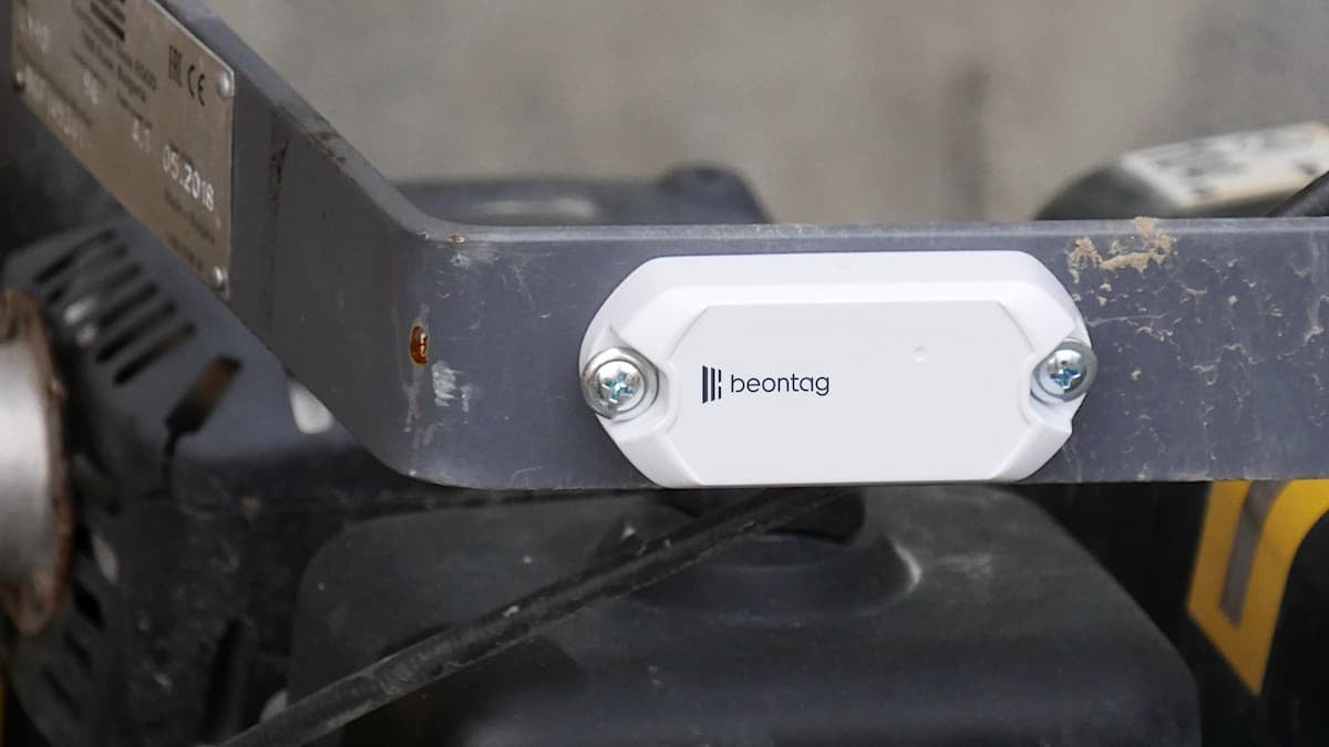 A close-up of a Beontag RFID hard tag mounted with screws on industrial equipment.