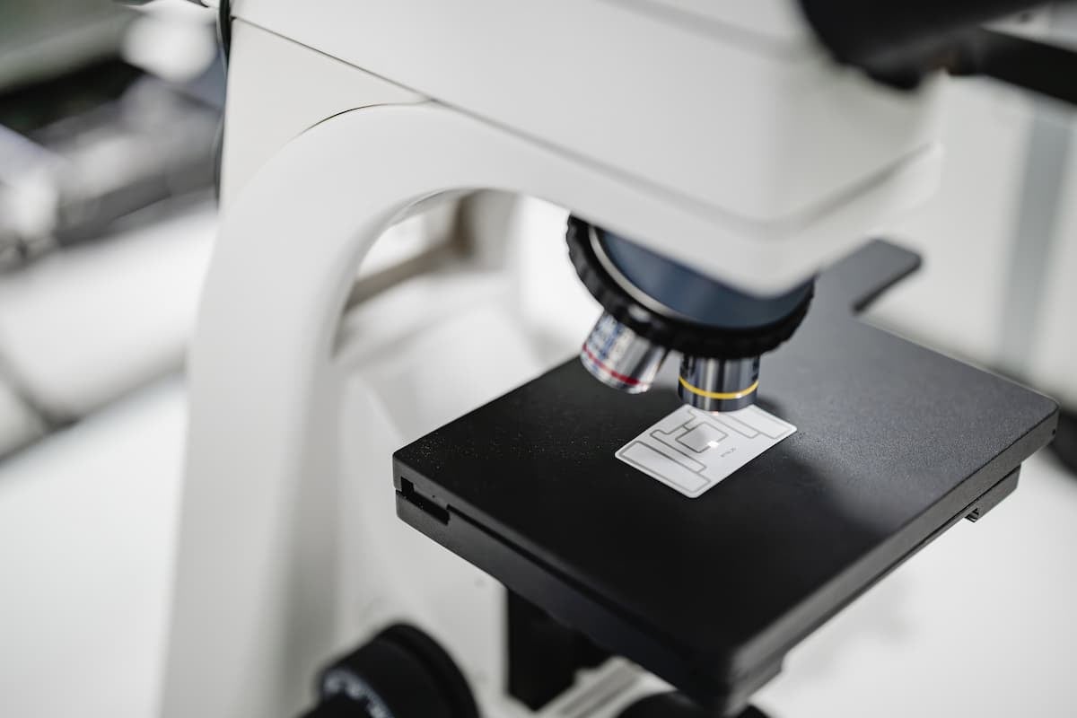 RFID tag antenna inspected under a microscope in the lab.