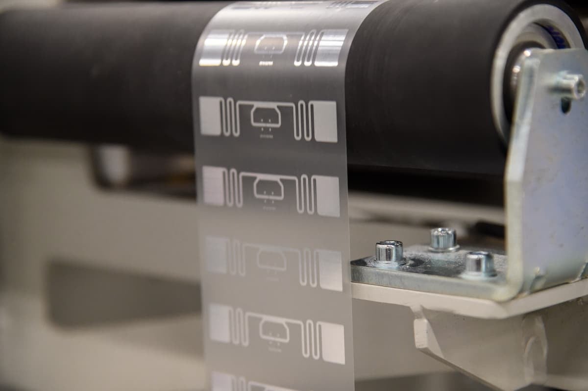 Close-up of RFID inlays being produced on a smart label manufacturing roll.